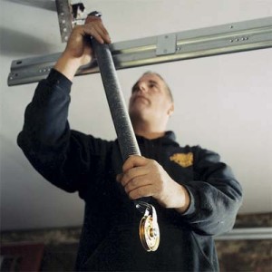 technician performing garage door repair in Toronto area home